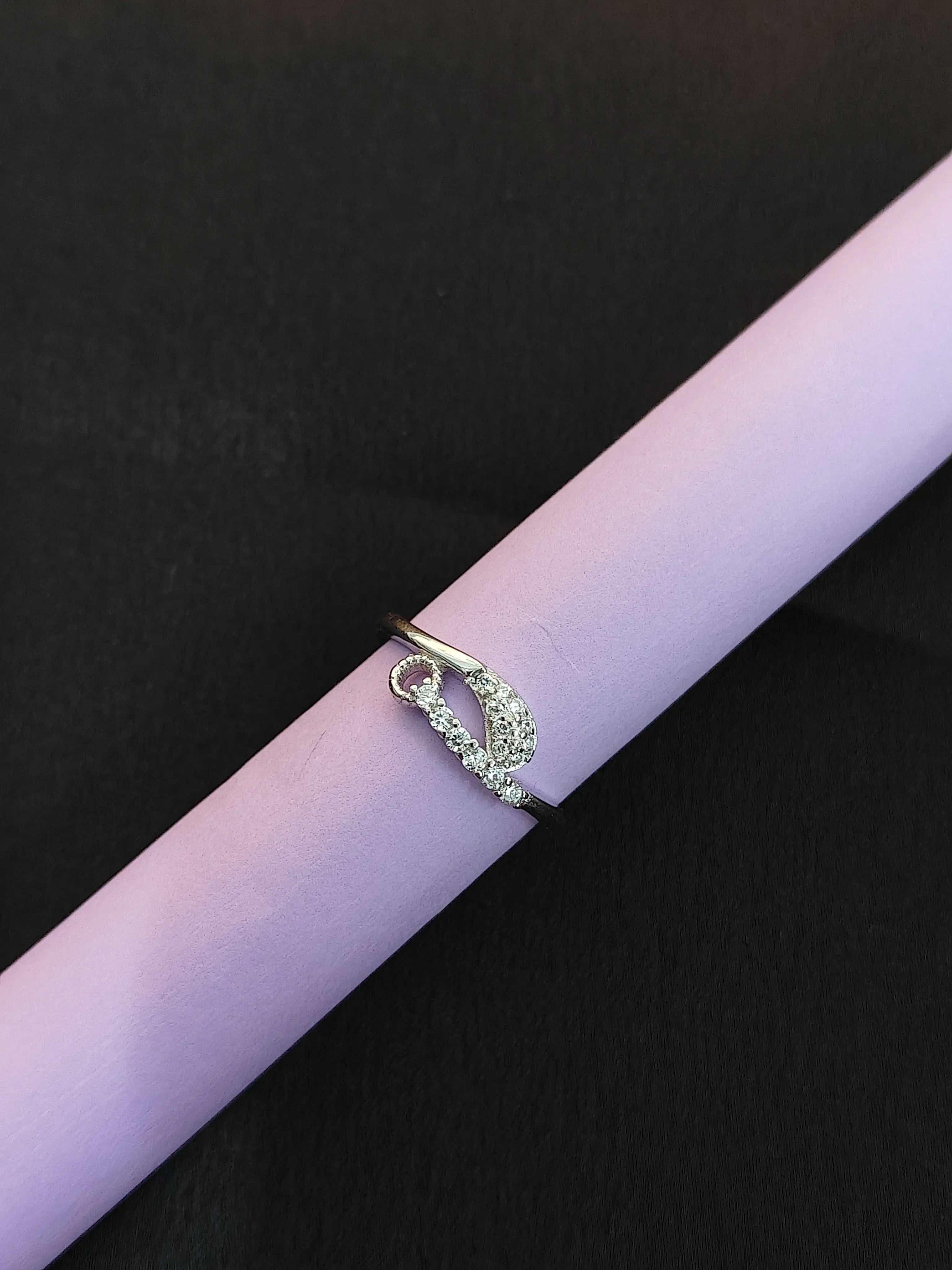 Silver ring with a unique design on a pink surface